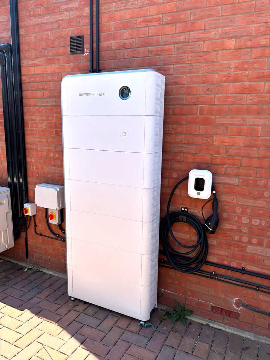 Sigenergy battery and EV charger on a brick wall, installed by Skylar Solar