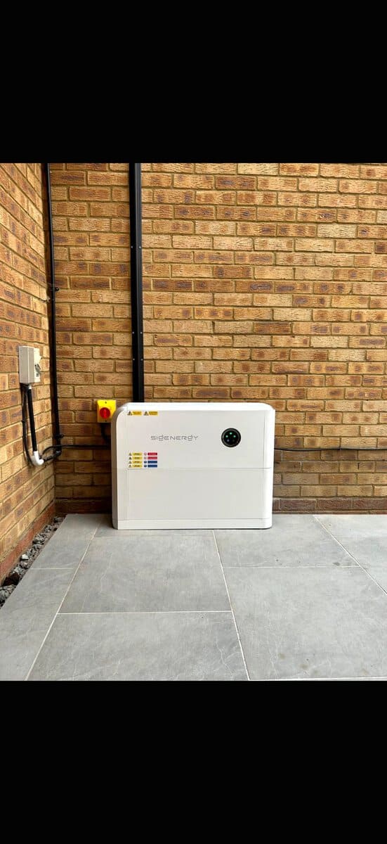 Outdoor SigEnergy battery on patio against brick