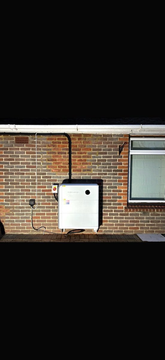 Wall-mounted SigEnergy battery on brick near window