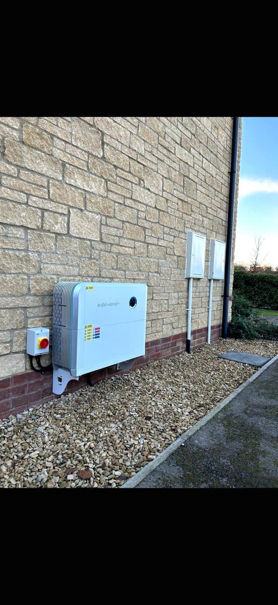 Outdoor SigEnergy system on stone wall