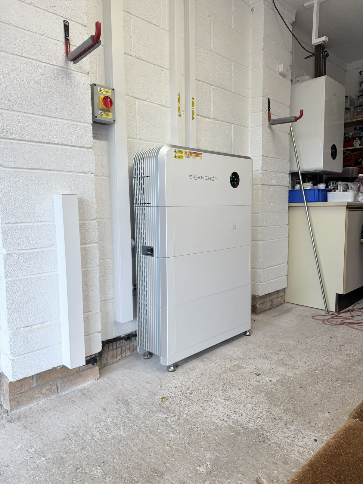 Stacked white Sigenergy SigenStor units installed in a utility room by Skylar Solar